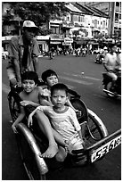 Kids sharing cyclo ride, Ho Chi Minh city. Vietnam ( black and white)
