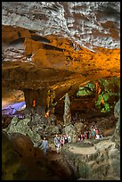 Tourists walking in cavernous chamber, Sungsot cave. Halong Bay, Vietnam ( color)