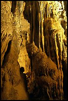 Tourist framed by cave formations, upper cave, Phong Nha Cave. Vietnam