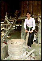 Woman of the Thai ethnicity milling grain, near Mai Chau. Northwest Vietnam ( color)