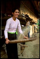 Woman of the Thai ethnicity sorting grain, near Mai Chau. Vietnam (color)