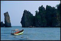 Small boats and offshore rock formations. Hong Chong Peninsula, Vietnam ( color)