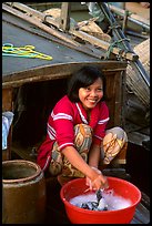 Woman doing laundry on live-aboard boat, the cheapest and most convenient housing in the Delta, near Can Tho. Vietnam