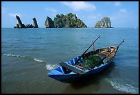 Boat and limestone towers, undeveloped beach. Hong Chong Peninsula, Vietnam