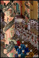 Priests and ornate columns inside the Great Caodai Temple. Tay Ninh, Vietnam ( color)