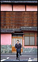 Bicyclist in front of a traditional style house. Kyoto, Japan