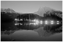 Lighted cabins and mountains reflected in Emerald Lake at night. Yoho National Park, Canadian Rockies, British Columbia, Canada (black and white)