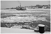 Ferry crossing the Saint Laurent river partly covered with ice, Quebec City. Quebec, Canada (black and white)