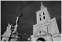 Crucifix and romanesque tower of Notre-Dame-des-Doms Cathedral. Avignon, Provence, France ( black and white)