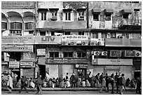Street with many people waiting in front of closed stores, Old Delhi. New Delhi, India ( black and white)