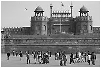 Tourists walking on esplanade in front of the Lahore Gate. New Delhi, India (black and white)