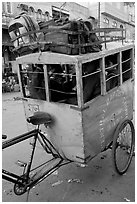 Schoolchildren in an enclosed  box towed by cycle. New Delhi, India ( black and white)