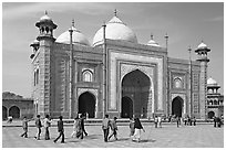 Taj Mahal masjid with people strolling. Agra, Uttar Pradesh, India (black and white)