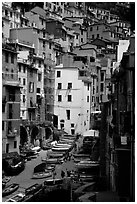 Plazza with parked boats built along steep ravine, Riomaggiore. Cinque Terre, Liguria, Italy (black and white)