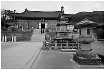 Three-story stone pagoda and main hall, Haeinsa Temple. South Korea (black and white)