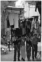 Children in a busy old town alley. Jerusalem, Israel (black and white)