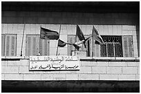 Palestinian flags and inscriptions in arabic in front of a school, East Jerusalem. Jerusalem, Israel (black and white)