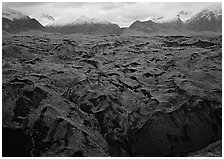 Glacier covered with black rocks. Wrangell-St Elias National Park, Alaska, USA. (black and white)