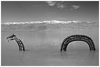 Loch Ness Monster art installation in Manly Lake and Panamint range. Death Valley National Park, California, USA. (black and white)