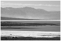 Salt Flats on Valley floor and Owlshead Mountains, early morning. Death Valley National Park, California, USA. (black and white)