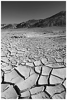 Mud cracks and Funeral mountains. Death Valley National Park, California, USA. (black and white)