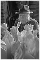 Miller sitting behind bags of cornmeal, North Carolina. Great Smoky Mountains National Park ( black and white)
