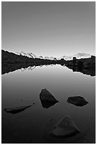 Rocks and calm lake with mountain reflections, early morning, Dusy Basin. Kings Canyon National Park ( black and white)