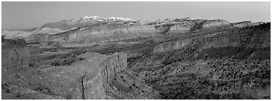 Panorama of multi-hued cliffs and Henry Mountains at dusk. Capitol Reef National Park (Panoramic black and white)