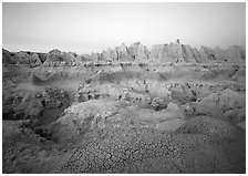 Cracked mudstone and eroded towers near Cedar Pass, dawn. Badlands National Park, South Dakota, USA. (black and white)