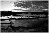 Great Fountain geyser and colorful clouds at sunset. Yellowstone National Park, Wyoming, USA. (black and white)