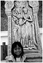 Girl and sculpture at Wat Phnom. Phnom Penh, Cambodia (black and white)