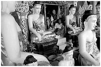 Surrounded by Buddha statues, Shwedagon Paya. Yangon, Myanmar (black and white)