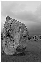 Standing stone and chapel at dusk, Avebury, Wiltshire. England, United Kingdom (black and white)