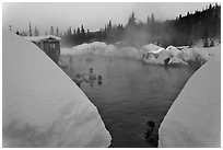 Soaking in natural hot pool surrounded by snow. Chena Hot Springs, Alaska, USA (black and white)