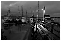 Deck and boats at night. Morro Bay, USA ( black and white)