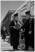 Graduate wearing lei presented with diploma. Stanford University, California, USA ( black and white)