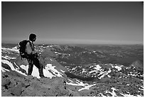 Hiker standing on top of Round Top Peak. Mokelumne Wilderness, Eldorado National Forest, California, USA ( black and white)