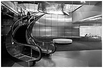 Curved moving staircase and meeeting room, Bloomberg building. NYC, New York, USA (black and white)