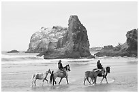 Women horse-riding on beach. Bandon, Oregon, USA ( black and white)