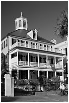 Couple walking in front of antebellum house. Charleston, South Carolina, USA ( black and white)