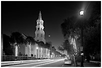 St Michael Episcopal Church and street with traffic at night. Charleston, South Carolina, USA ( black and white)