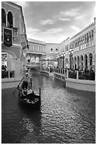Gondolier singing song to couple during ride inside Venetian casino. Las Vegas, Nevada, USA (black and white)