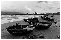 Coracle boats and city skyline. Da Nang, Vietnam (black and white)