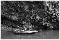 Fishermen anchor in cave for breakfast. Halong Bay, Vietnam (black and white)