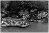 Fishermen anchor eating breakfast in cave. Halong Bay, Vietnam (black and white)