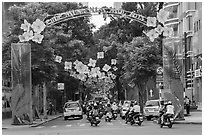 Street with holiday decorations. Ho Chi Minh City, Vietnam (black and white)