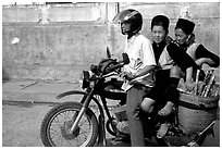 Black Hmong Women riding at the back of a Russian motorbike. Sapa, Vietnam ( black and white)