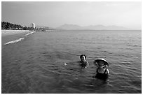 Early morning bath on a perfect beach Nha Trang. Vietnam ( black and white)