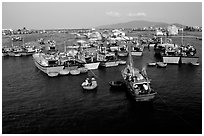 Colorfull fishing boats. Note the circular basket boats used to get to shore.  Nha Trang. Vietnam ( black and white)