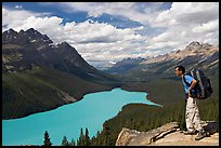 Hiker wearing backpack looking at Peyto Lake. Banff National Park, Canadian Rockies, Alberta, Canada